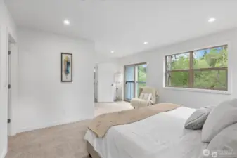 With its view of the trees, the primary bedroom is a tranquil, rejuvenating space.