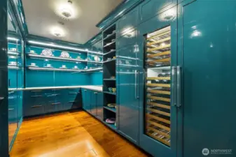 Larger group? Butler's pantry is here to serve, with discreet access from the 2nd elevator vestibule through the laundry area (2 sets of wifi-enabled washers/dryers, utility sink, etc.). Surrounded by ultra-high-gloss lacquer, the shelving is great for displaying your finest. Sub-Zero refrigerator, freezer and wine storage. Honed Azul Adobe limestone countertops; plumbed for espresso maker. Fun light fixtures.
