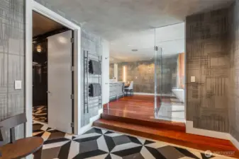 Custom large-format mosaic marble from Ann Sacks invites you to your restoration. Dual white quartzite vanity plus dressing table under Venetian plaster and surrounded by hand-painted wallpaper; both by Seattle artist Cathy Conner. Discreet water closet (with Toto Aquia washlet). Grab a heated towel and enjoy.