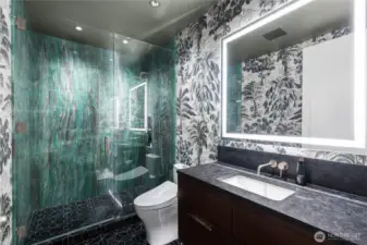 Blomma marble floor tile. Polished emerald quartzite shower walls. De Gournay hand painted wall paper. Leathered antique brown granite countertop. Toto Aquia washlet toilet