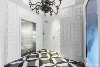 One of two secure elevator vestibules. Arrive to custom black-glass fire breathing dragon light-as-art with hidden gem. Egg and dart moulding. 98" commercial display (currently showing Blackdove art). Ann Sacks honed custom-mosaic marble. Your guests will be glad they came.