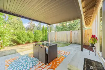 Entertain as space inside and outside flow together between sliding door and louvered pergola.