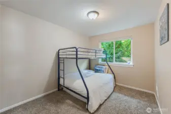 Guest room/office/den with closet. View of greenery in front of the window.