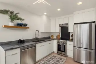 All new stainless appliances. Custom black herringbone tile backspace behind range