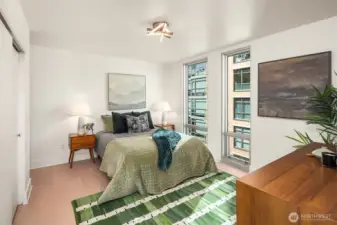 Generous primary bedroom with floor-to-ceiling windows