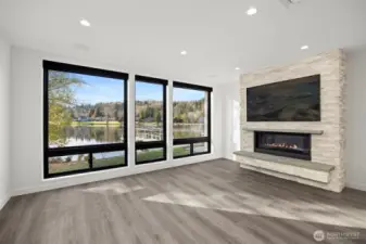 The spacious living room has a wall of floor-to-ceiling windows that take in the stunning lake views.