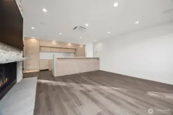 Looking across the living room toward the kitchen with the beverage niche below the counter at the kitchen.