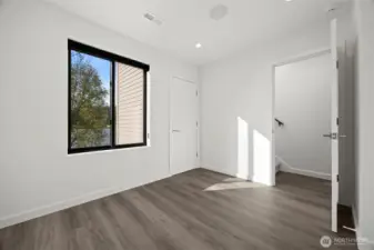 The bedroom on the main floor takes in the views of the lake and has a large closet.