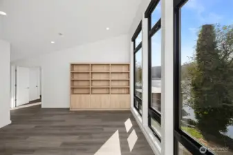 The other room upstairs is ideal for a family or rec room and has beautiful built-ins and floor-to-ceiling windows that look out to Big Lake.