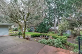 Nicely landscaped backyard with outbuildings.