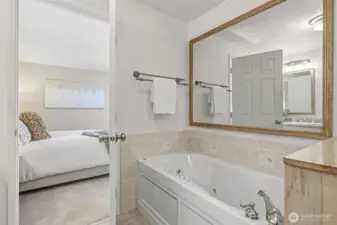 Serene primary suite with full bath en suite including a jetted tub.