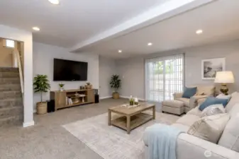 The family room has been completely remodeled blending modern comfort with timeless warmth. A gas fireplace provides a cozy centerpiece for gatherings and relaxing evenings. Sliding glass door invites abundant natural light and opens to a patio. Fresh, updated finishes and thoughtful design create a bright, inviting space.  Virtually staged