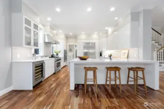 The epicurean kitchen is a chef's delight, showcasing gorgeous quartz counters, a state-of-the-art 6 burner stove, walk-in pantry, wine cooler, top of the line Miele dishwasher and a built-in Miele coffee and cappuccino machine.