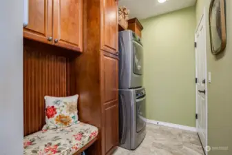 Laundry room has extensive cabinetry. Door opens to attached 2-car garage.