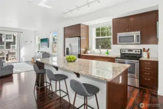Modern open concept floor plan on the main level. Solid granite slab island and hardwoods too.