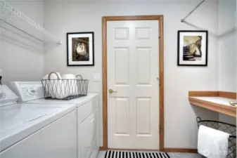 Laundry room with storage connects to garage
