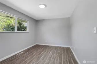 Bright and airy, this secondary bedroom offers serene tree-filled views and flexible space to grow with your lifestyle—whether you're setting up a nursery, office, or hobby room.