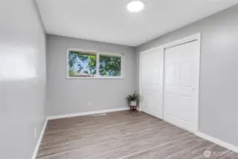 Third bedroom, highlighting its double closet doors and abundant natural light. Clean lines and neutral tones make it a breeze to style.