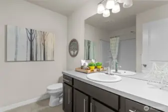 Full en-suite guest bathroom with sleek finishes and tub/shower combo for versatile use.
