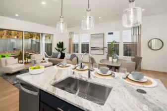 Light and bright kitchen open to great room space and dining area