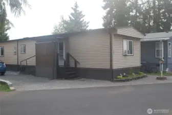 Side of the home showing stairs and ramp