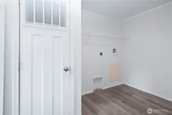 Laundry room with door to backyard.