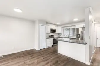 The updated kitchen has a convenient island where you can sit to eat or socialize.