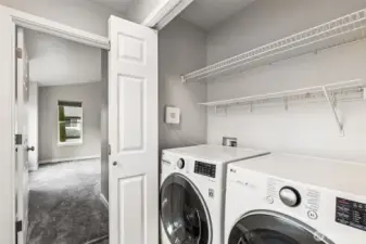 The utility closet with its washer and dryer is conveniently located between all three upstairs bedrooms.