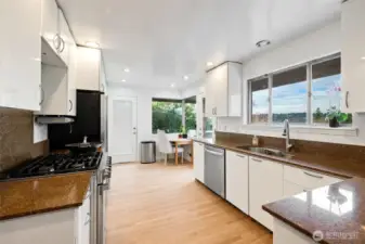 Bright kitchen with an eat-in space that opens to the deck and captures the view