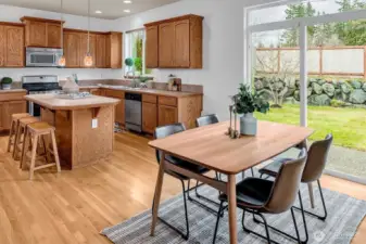 Sliding doors open to the expansive backyard deck, ideal for entertaining, while the fully fenced yard.