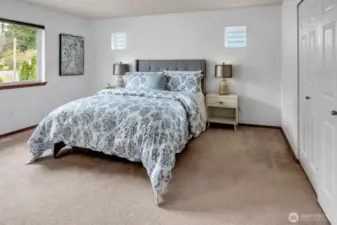 The primary suite boasts an en-suite bath with a double vanity and a deep soaking tub, and a large walk-in closet.