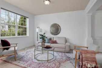 The formal living room flows gracefully into the elegant dining room.