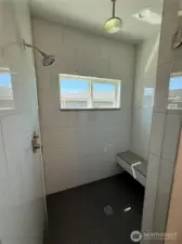 Primary walk-in tiled shower