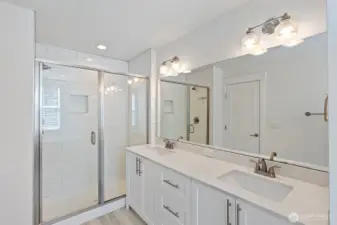 Enjoy double vanities, quartz countertops, an oversized shower and....
