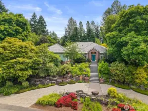 Don't you just love a circular drive!  This home is perched above the street and sits on a flat 1.4 acre lot.  A rare opportunity for single level living in a fantastic neighborhood!  Avoid the stairs by parking next to the garage on the left side of the home.