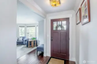 Traditional stained glass light fixture and hardwoods welcome