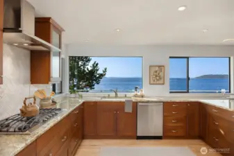 Fresh and functional, the kitchen offers spacious counters, great storage (adjacent pantry + additional storage beyond) and openness allowing for conversations with friends while prepping for meals. The sink is facing the views so as to fully take advantage of the scenery while prepping.