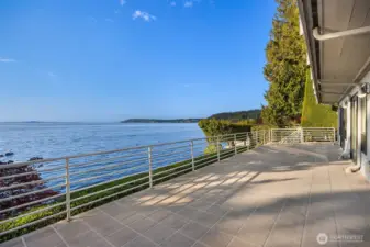 Bedroom level deck with stairs leading to the grounds and beach. Your four-legged friends will love to rush to their favorite beach playground after a good night of rest.