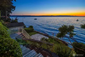 An easy trail leads to the fabulous and sizable yard. It is quite unusual for beachfront properties to have so much usable land and grounds on the water's edge. Here you will find patio and shed and enough lawn to get that fresh cut grass smell around you.