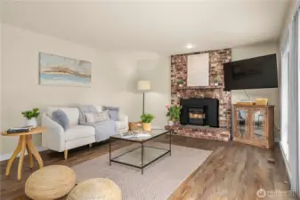 The brick fireplace has a wood stove that will be warm and welcoming this winter.
