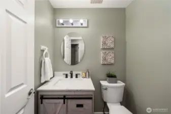 This remodeled half bath is off the entry on the main floor.