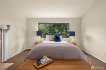 The primary suite is spacious and private.  The window looks out the tranquility of the back yard.