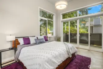 A spacious primary suite with a private deck