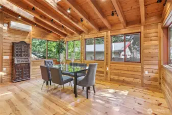 Spacious formal dining area wrapped in windows, perfect for gatherings.