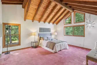 Bright and spacious primary retreat with vaulted ceilings, ensuite bath, and generous walk-in closet