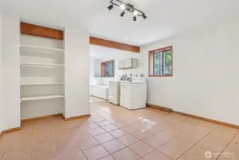 Generous lower-level laundry area with plenty of space for organization.