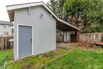 Nice large shed with covered area.