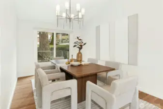 Large dining room with view to the front and sliding door to the front deck for a warm season dining flow!