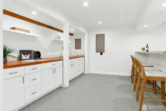 This storage and counter area has a functioning bar sink, and is plumbed for a future dishwasher should you wish to install one.