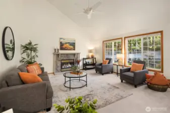 Open-concept main living area with vaulted ceilings and propane fireplace.